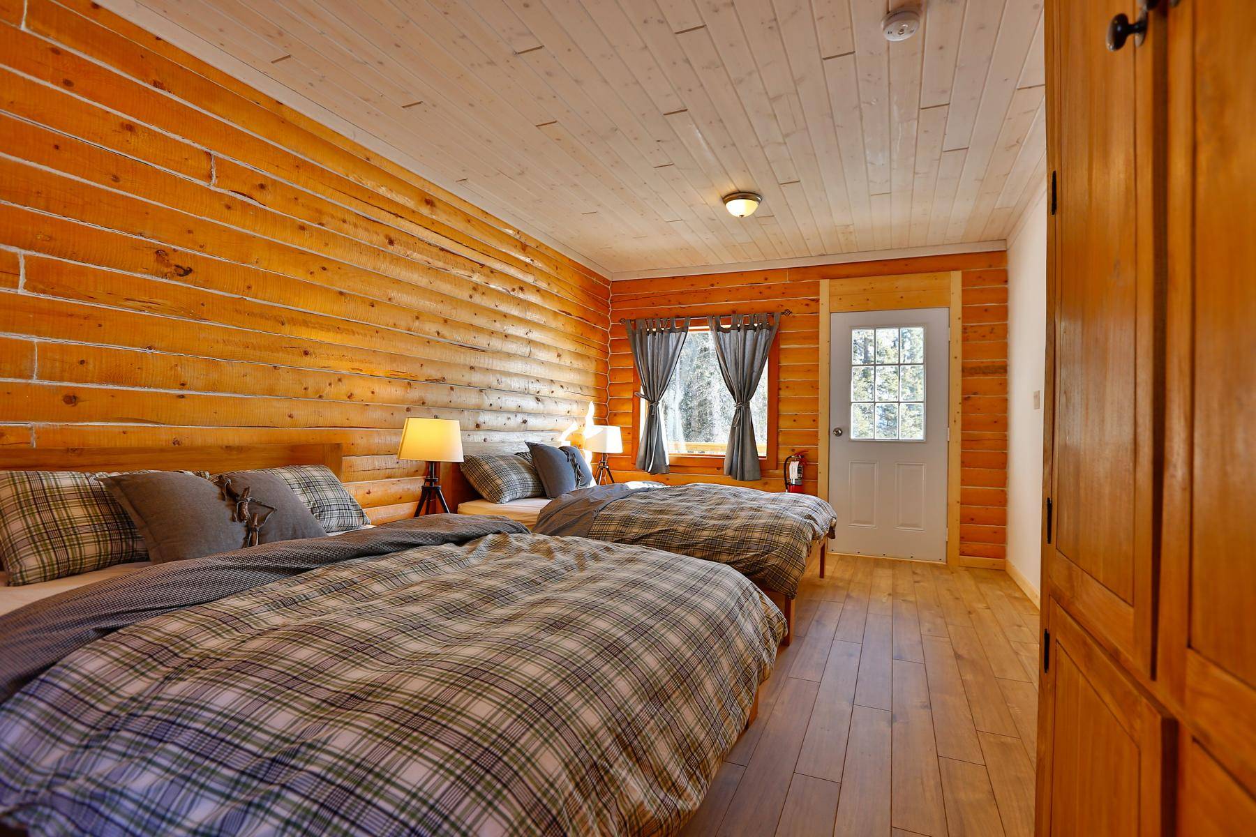 Interior of a standard lakefront cabin with 2 queen size beds