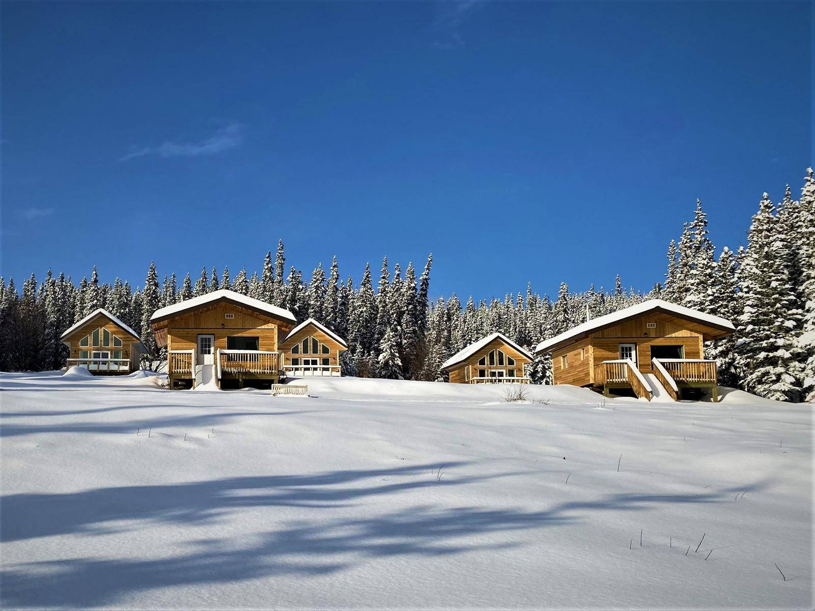 Front view on several of the cabins in deep winter with thick snow
