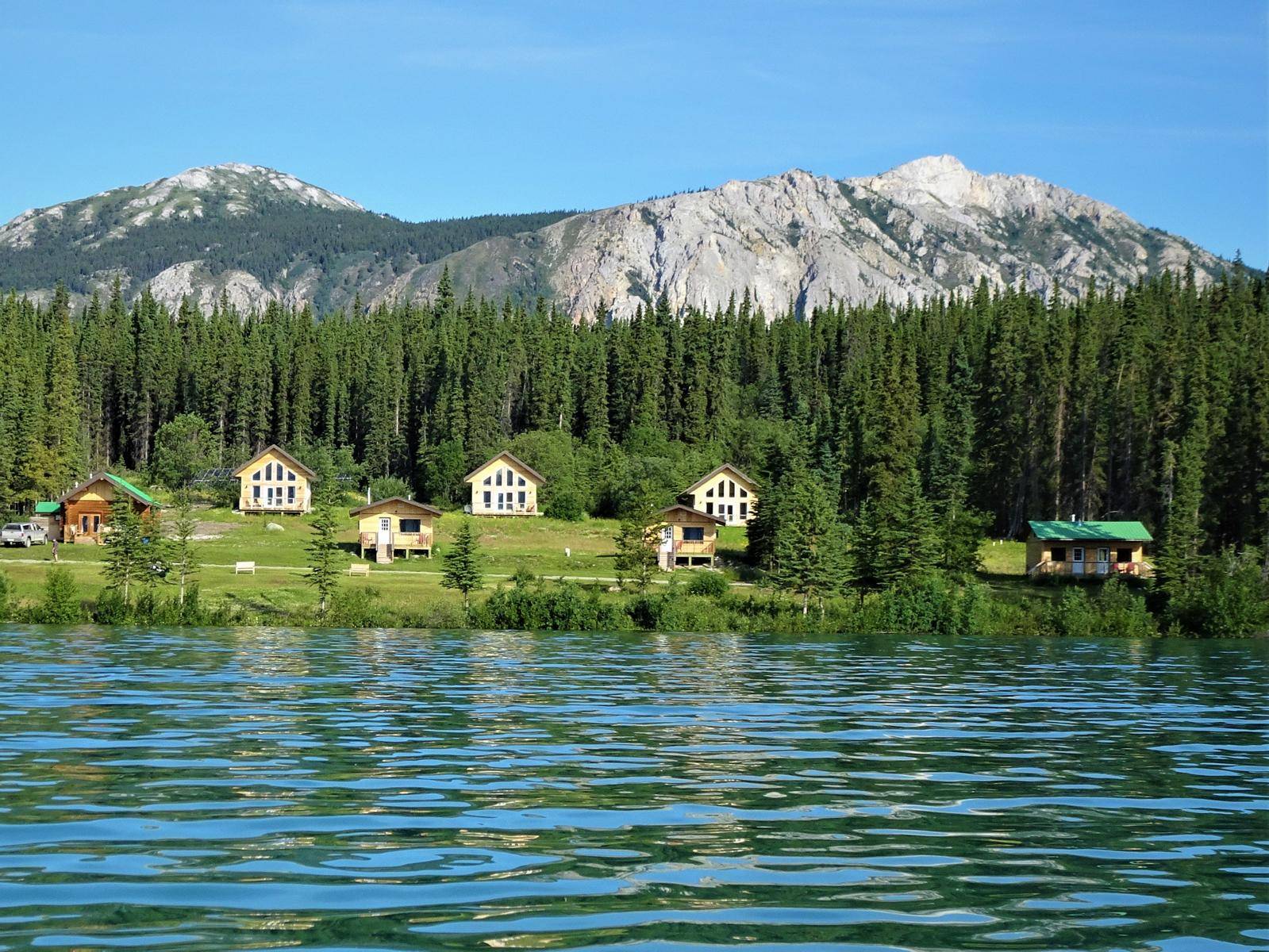 view over lake to resort with mountains in background