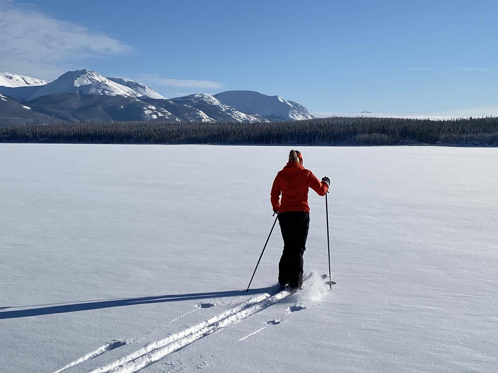 woman cross-country-skiing on frozen lake