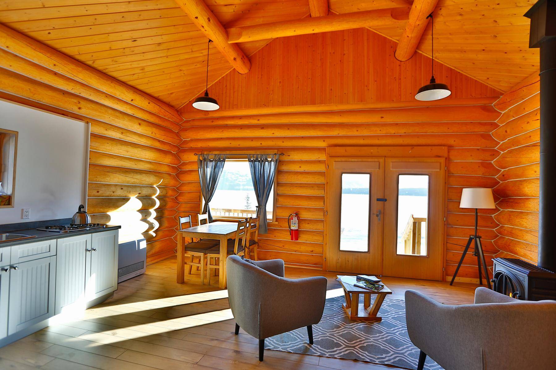 living room in family cabin, furniture and kitchen and stove