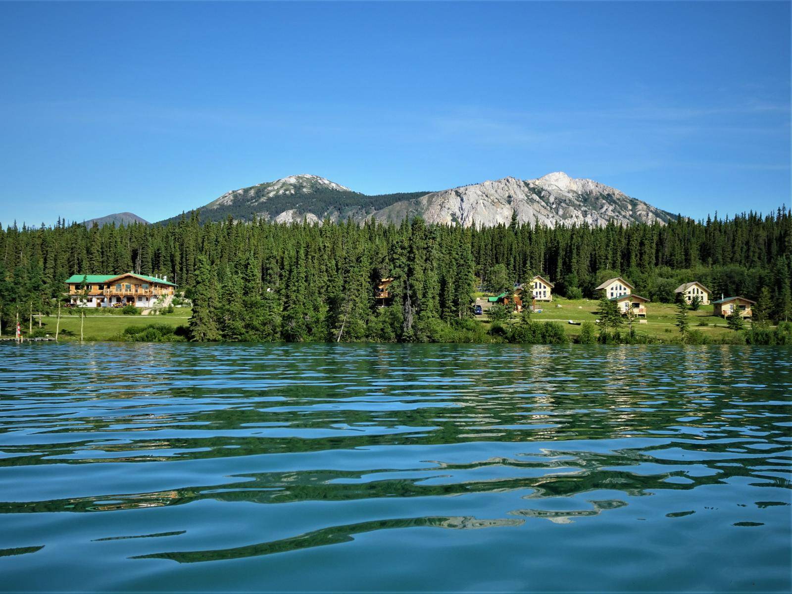 view over water from lake to resort and mountains